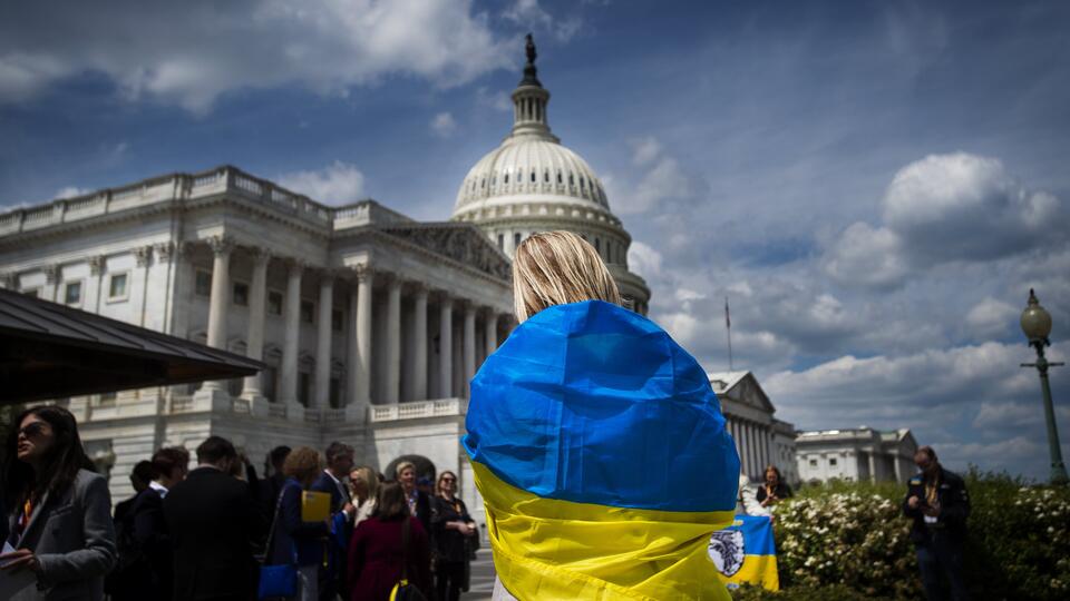 Девушка с флагом Украины стоит перед Капитолием в США